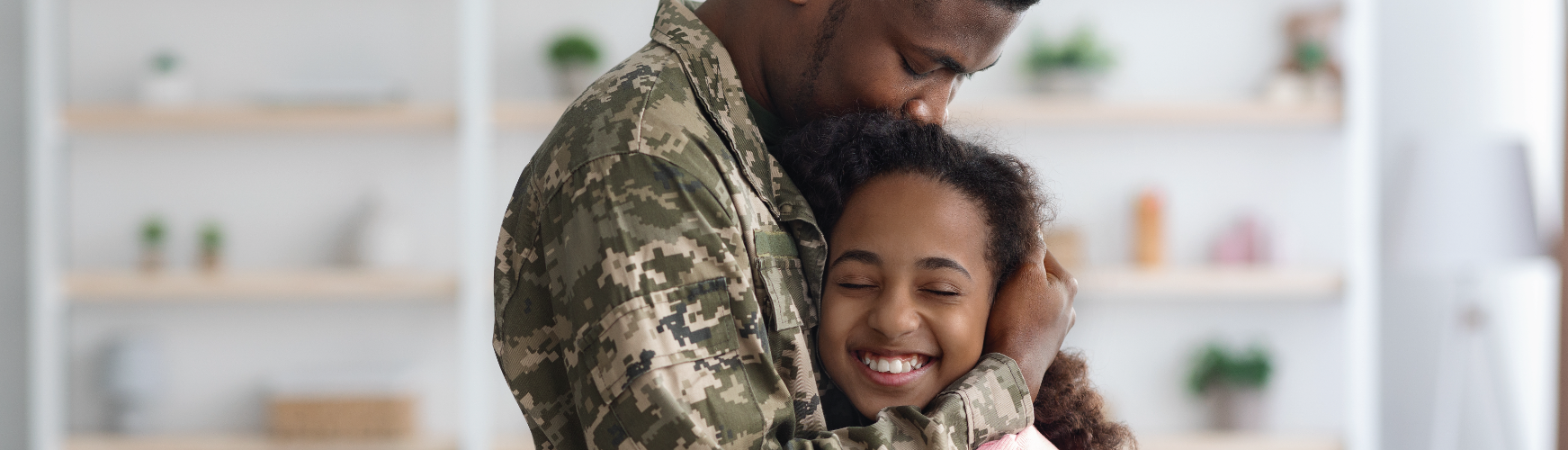 daughter hugging military dad
